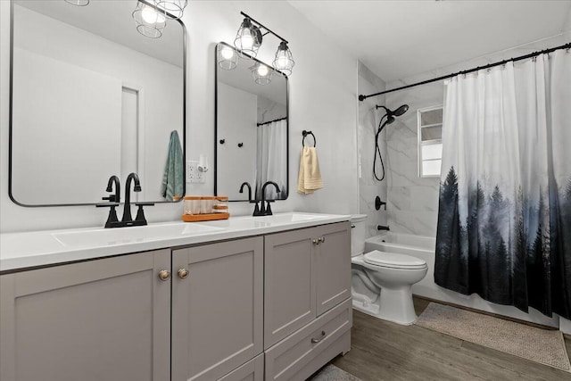 full bath featuring a sink, double vanity, wood finished floors, and shower / tub combo