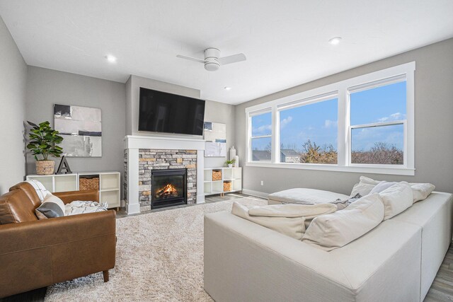 living area with recessed lighting, baseboards, ceiling fan, and a fireplace