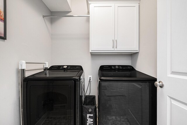 laundry area featuring washer and dryer and cabinet space