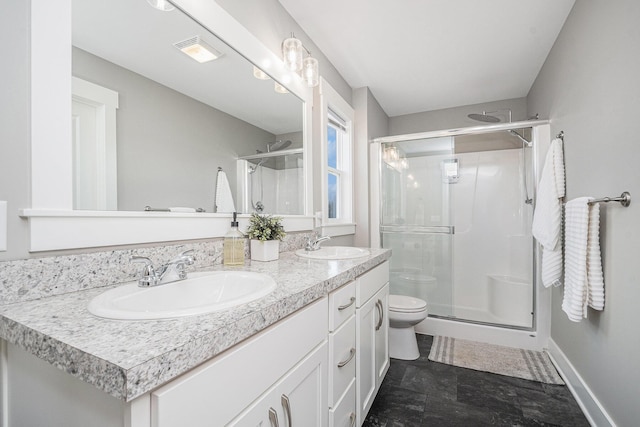 bathroom with double vanity, visible vents, a stall shower, and a sink