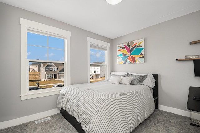 carpeted bedroom featuring visible vents and baseboards