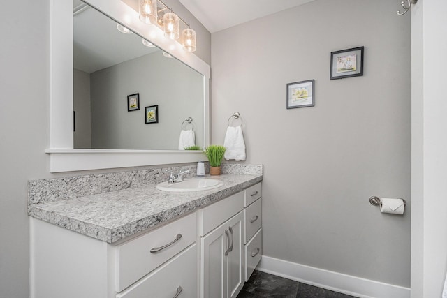 bathroom featuring baseboards and vanity