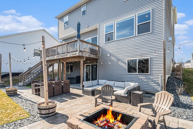 rear view of house with stairs, a patio area, an outdoor living space with a fire pit, and a wooden deck