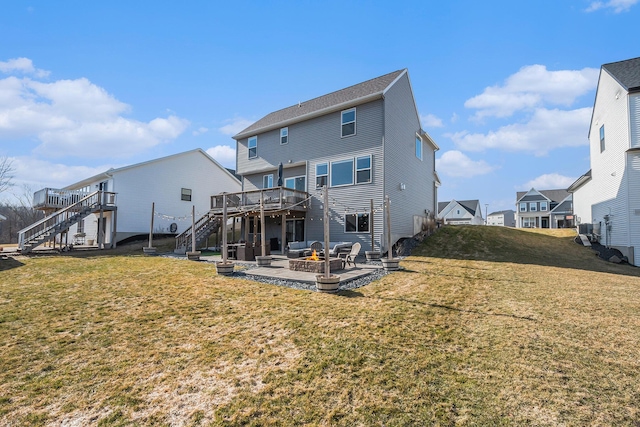 back of house featuring stairway, an outdoor fire pit, a yard, a deck, and a patio area