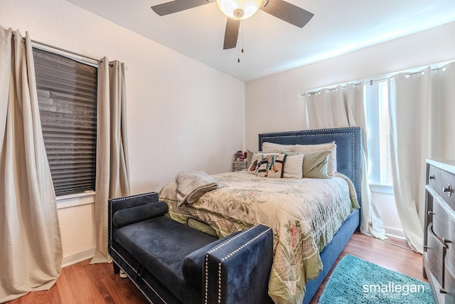 bedroom featuring a ceiling fan, wood finished floors, and baseboards