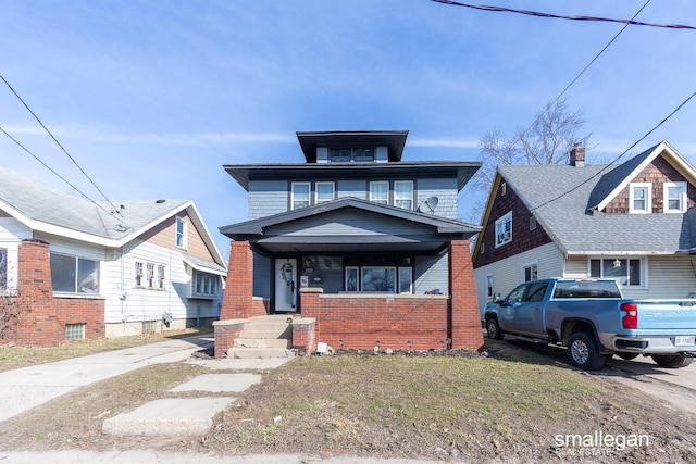 american foursquare style home with brick siding and a porch