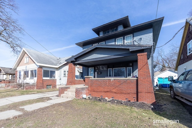 american foursquare style home with brick siding