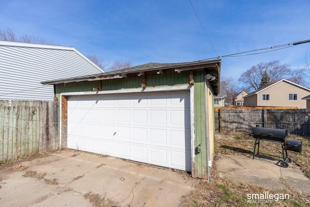 detached garage featuring fence