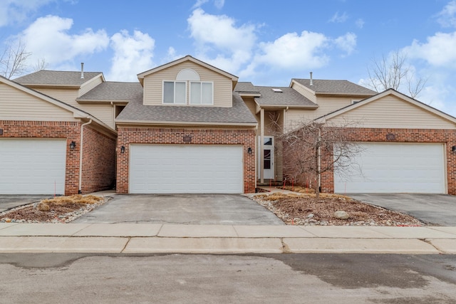 view of front of property with brick siding, driveway, and roof with shingles