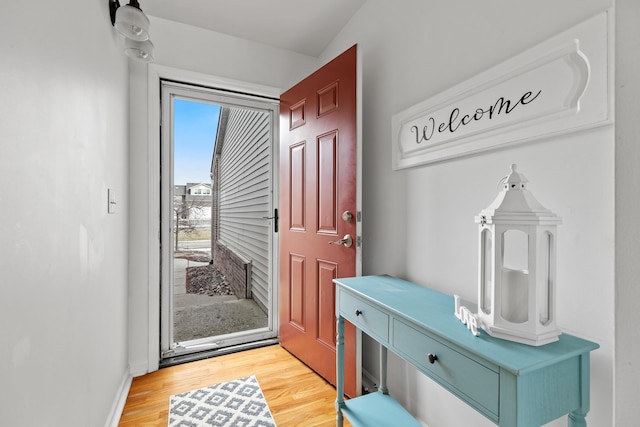 entryway featuring baseboards and wood finished floors