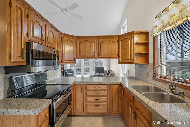 kitchen with a sink, stainless steel appliances, and brown cabinetry