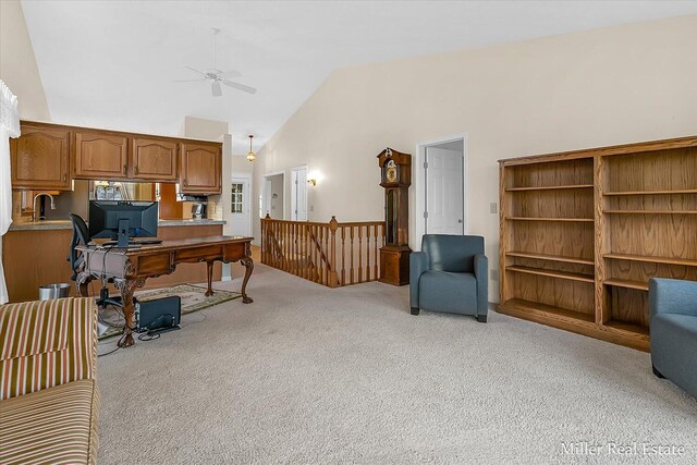 office space featuring light colored carpet, high vaulted ceiling, and a ceiling fan