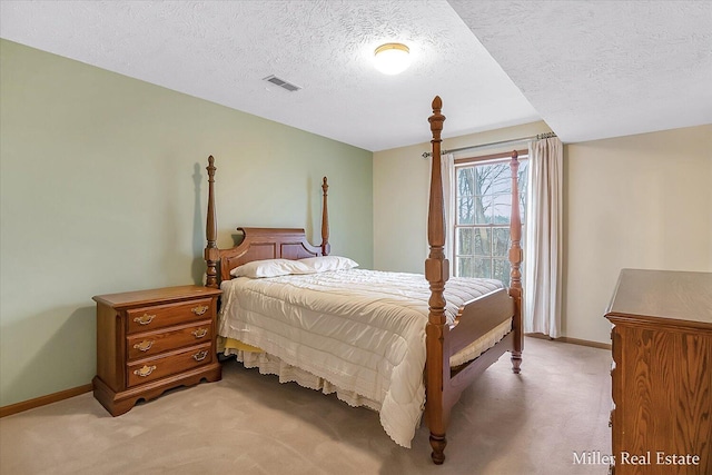 bedroom with baseboards, visible vents, and light carpet