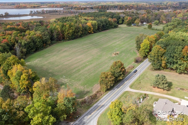 aerial view with a forest view and a water view