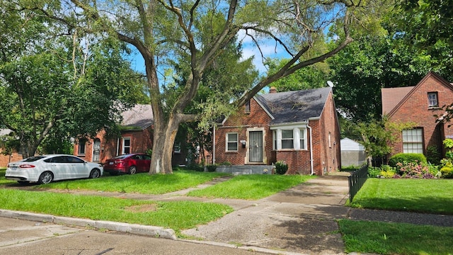 view of front of home with brick siding and a front lawn