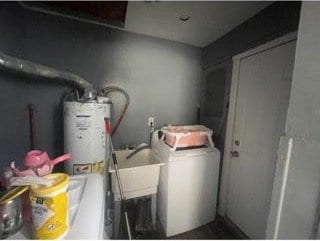 utility room featuring gas water heater