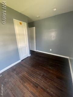 6390 Faust Ave, Detroit, MI 48228 - unfurnished bedroom with dark wood-type flooring and baseboards