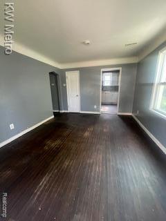6390 Faust Ave, Detroit, MI 48228 - unfurnished living room featuring baseboards and wood finished floors