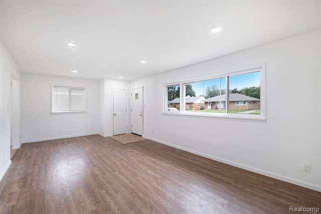 empty room featuring recessed lighting, wood finished floors, and baseboards