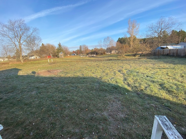 view of yard with a rural view and fence