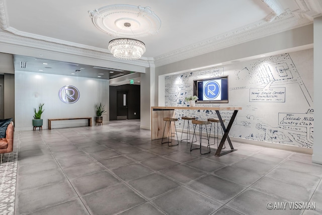 interior space with a notable chandelier, baseboards, and ornamental molding