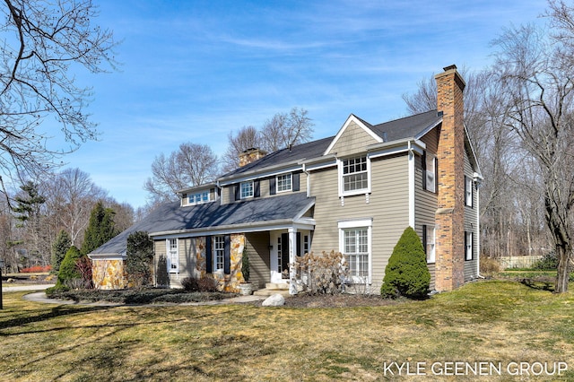 traditional home with a front lawn and a chimney