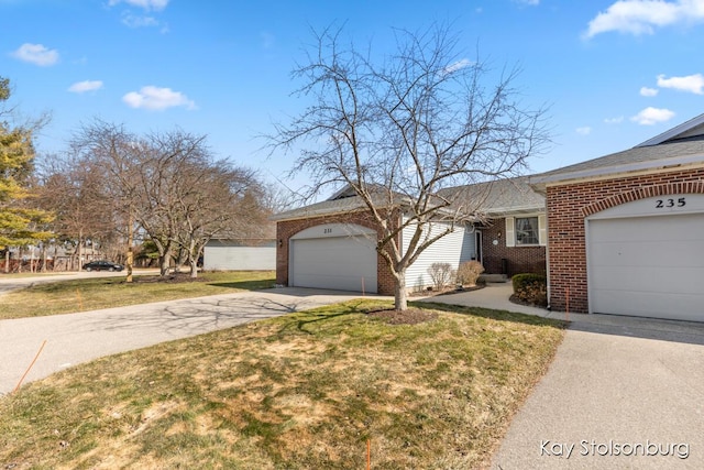 view of front of property with a front lawn, an attached garage, brick siding, and driveway