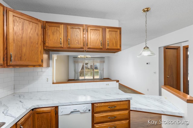 kitchen featuring brown cabinets, tasteful backsplash, pendant lighting, and white dishwasher