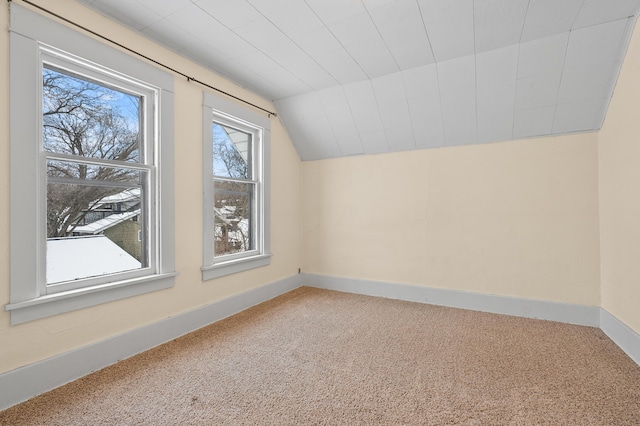 bonus room with baseboards, carpet floors, and lofted ceiling