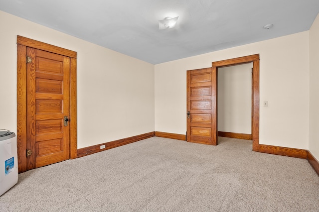 carpeted spare room with baseboards