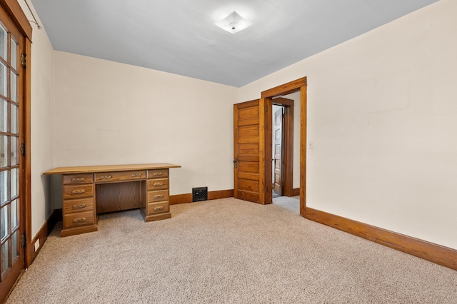 unfurnished bedroom featuring baseboards and carpet