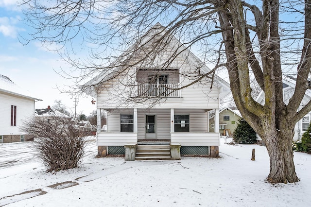 view of front facade with a balcony and covered porch