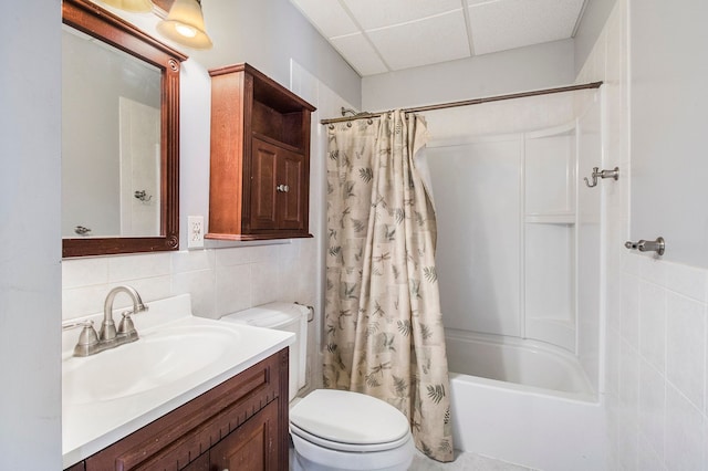 bathroom with shower / bath combo with shower curtain, toilet, tile walls, decorative backsplash, and vanity