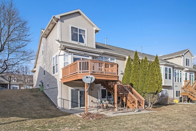 back of property with stairway, a patio, a lawn, and a wooden deck