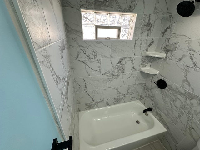 bathroom with bathing tub / shower combination