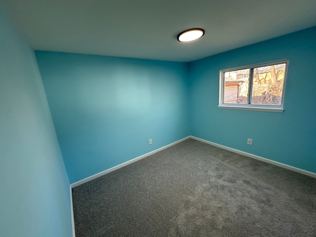 empty room featuring baseboards and carpet floors