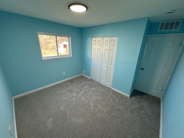 unfurnished bedroom with visible vents, baseboards, a closet, and carpet flooring