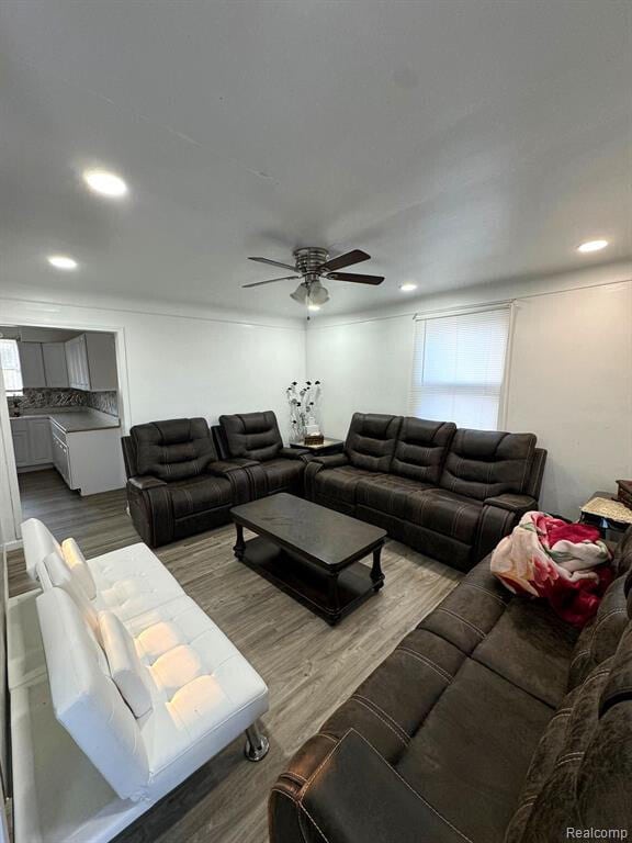 living area with recessed lighting, wood finished floors, and a ceiling fan