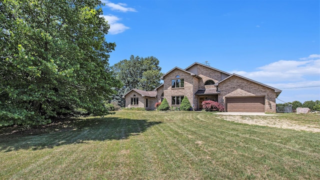 view of front of house with a front yard, an attached garage, and brick siding