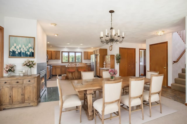 dining space with recessed lighting, an inviting chandelier, and stairs