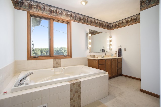 bathroom featuring vanity, a bath, and baseboards