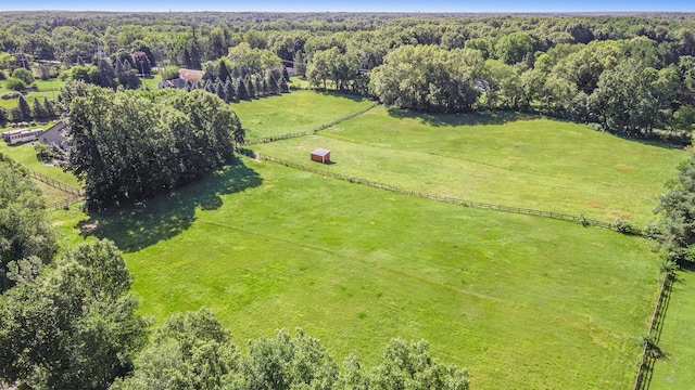 aerial view featuring a rural view and a wooded view