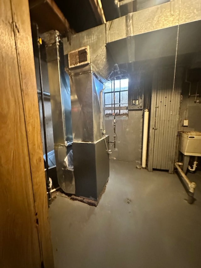 basement with a sink and heating unit