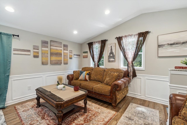 living area with vaulted ceiling, recessed lighting, wood finished floors, and wainscoting