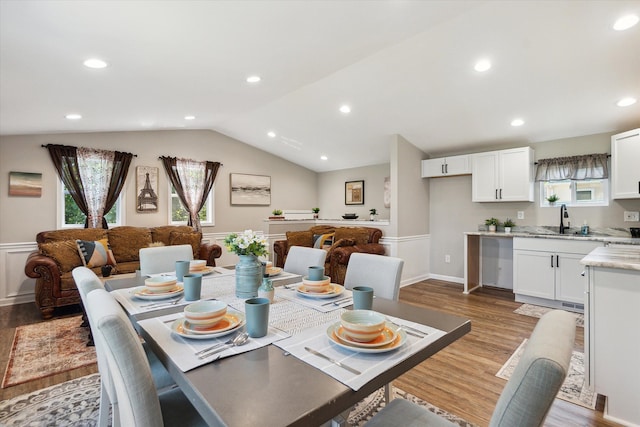 dining area featuring vaulted ceiling, plenty of natural light, wood finished floors, and recessed lighting