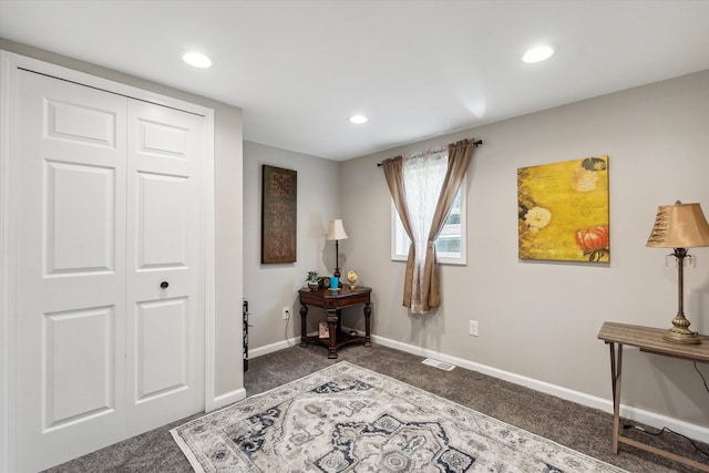 interior space featuring recessed lighting, baseboards, visible vents, and dark carpet