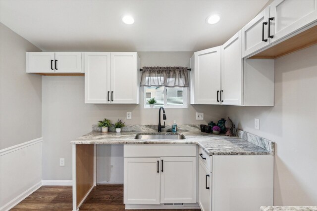 kitchen featuring white cabinetry, recessed lighting, dark wood-style flooring, and a sink