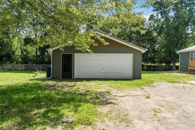 detached garage featuring fence