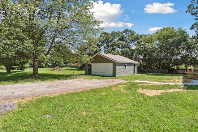 view of yard with a garage, an outdoor structure, and fence