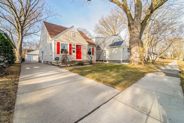 bungalow-style house with a front yard, roof with shingles, an outdoor structure, a garage, and board and batten siding